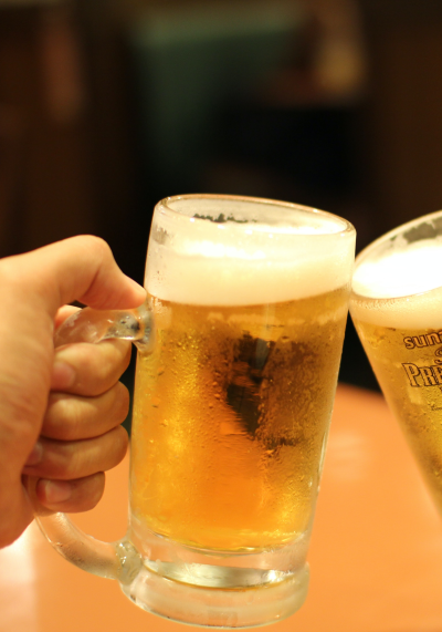 Zwei Freunde stoßen mit Bier an